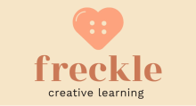 Logo with a heart containing 4 button holes and the words Freckle Creative Learning