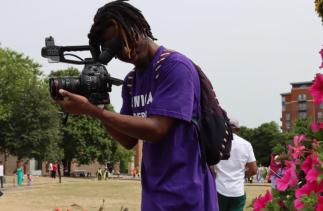 Mthabisi Mlauzi taking photographs at the Derby Caribbean Carnival