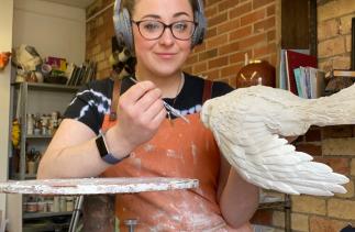 Abbie Sunter ceramic artist working on a new piece sculpting an eagle